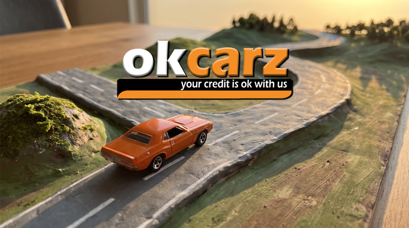Toy car at a fork between a short road and a long winding road, representing short and long loan terms. The OK Carz logo sits center-screen.